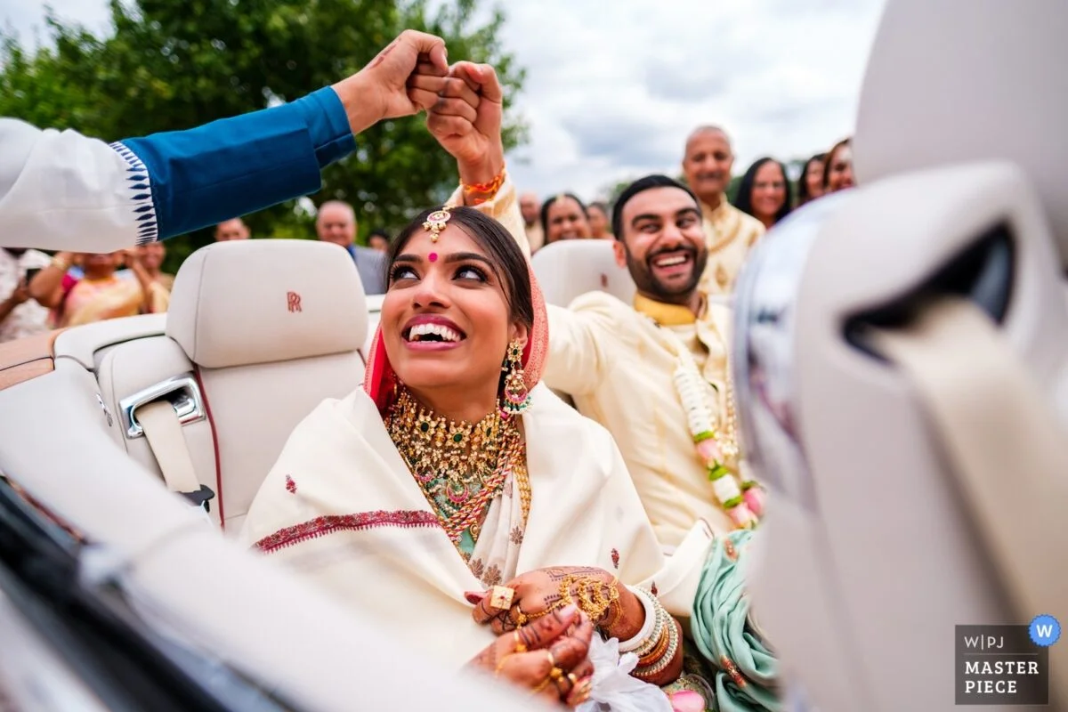 An indian bride and groom in a car.