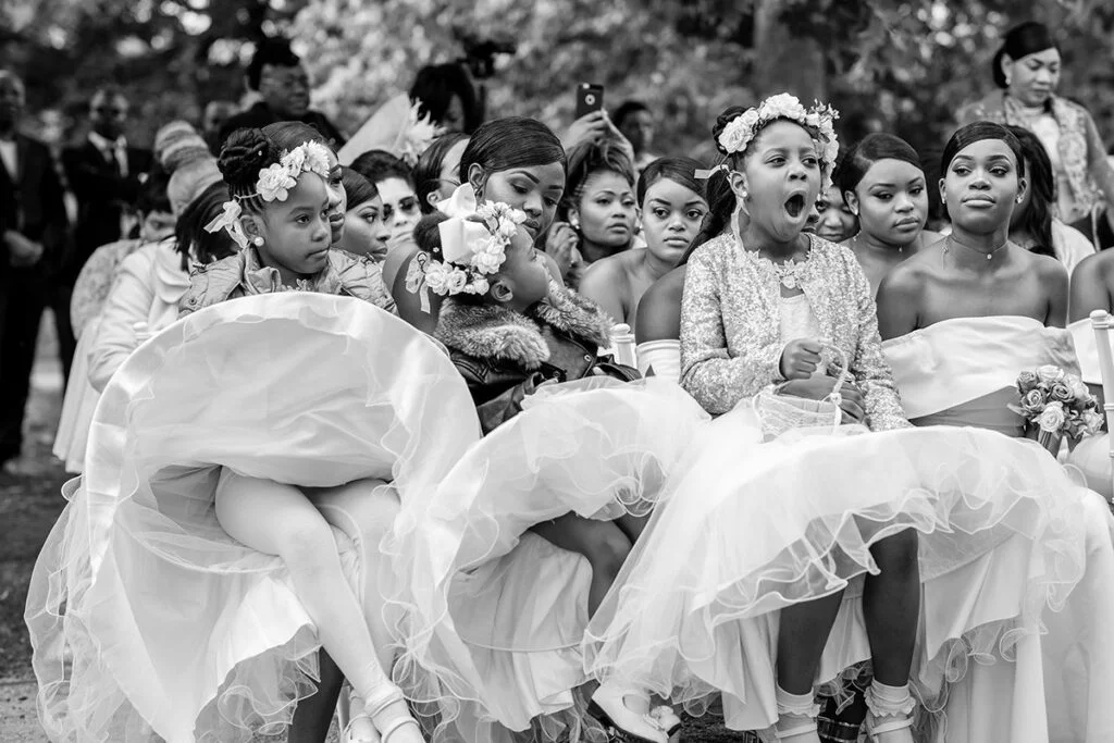 A black and white photo of bridesmaids in wedding dresses.
