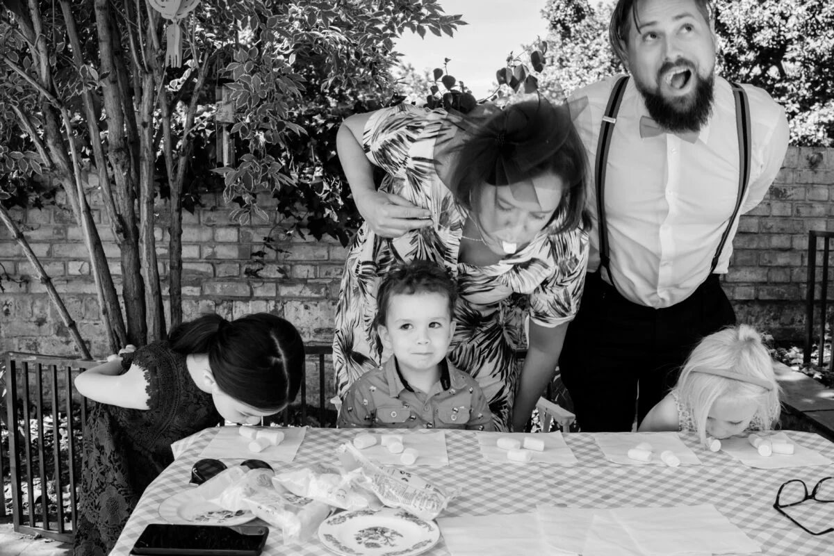 A black and white photo of a family at a table.