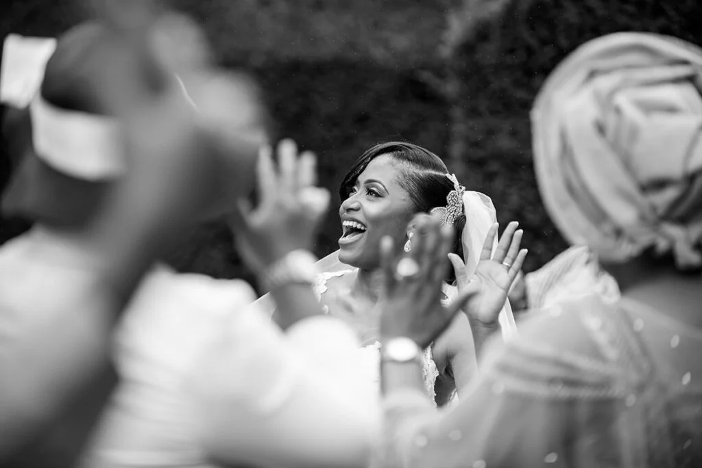 A black and white photo of a woman clapping.