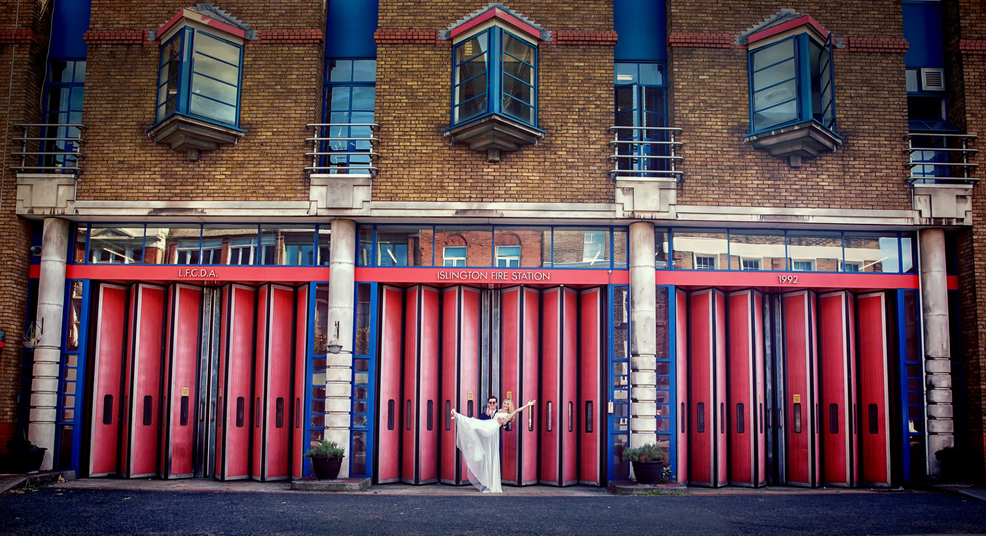 Bride-and-groom-pose-outside-Islington-Fire-Station-on-wedding-day (listing)