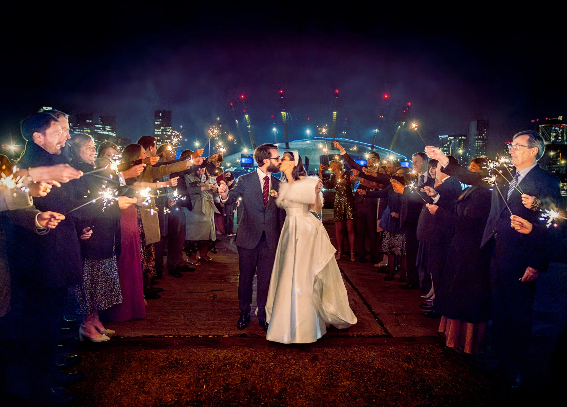 Trinity-Bouy-Wharf-Wedding-sparklers-shot-with-bride-and-groom-and-O2-in-background (listing)