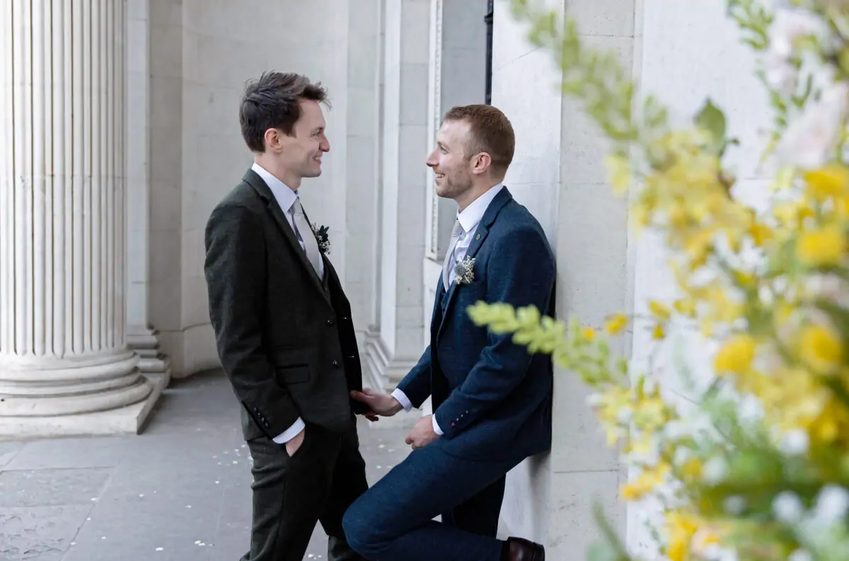 Two-grooms-romantic-moment-at-Old-Marylebone-Town-Hall-wedding