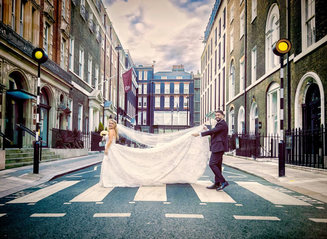 A bride and groom walking down a street in london.