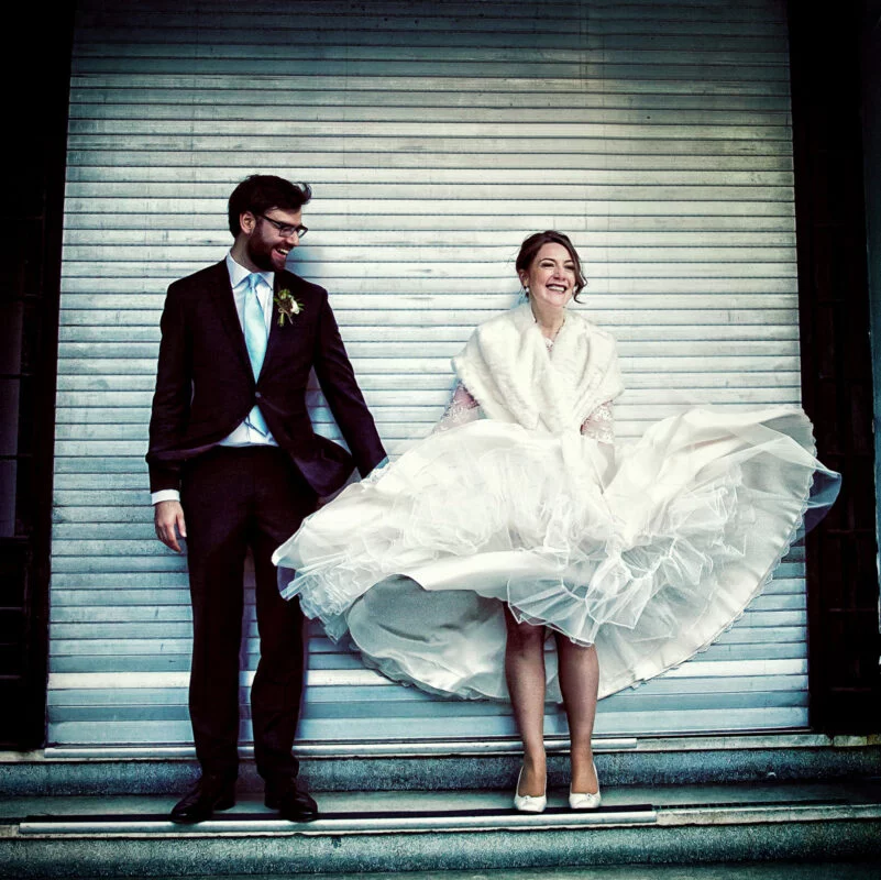 A bride and groom in a wedding dress.