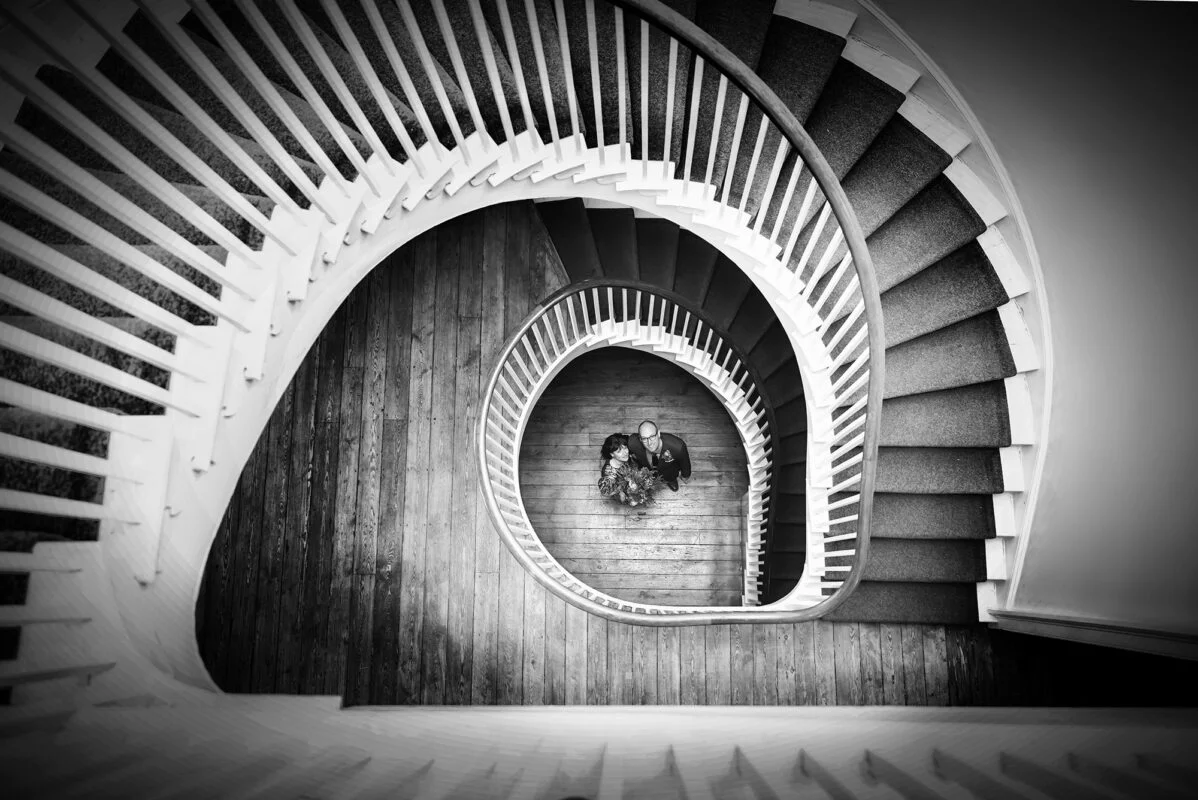 A spiral staircase in black and white metal print.