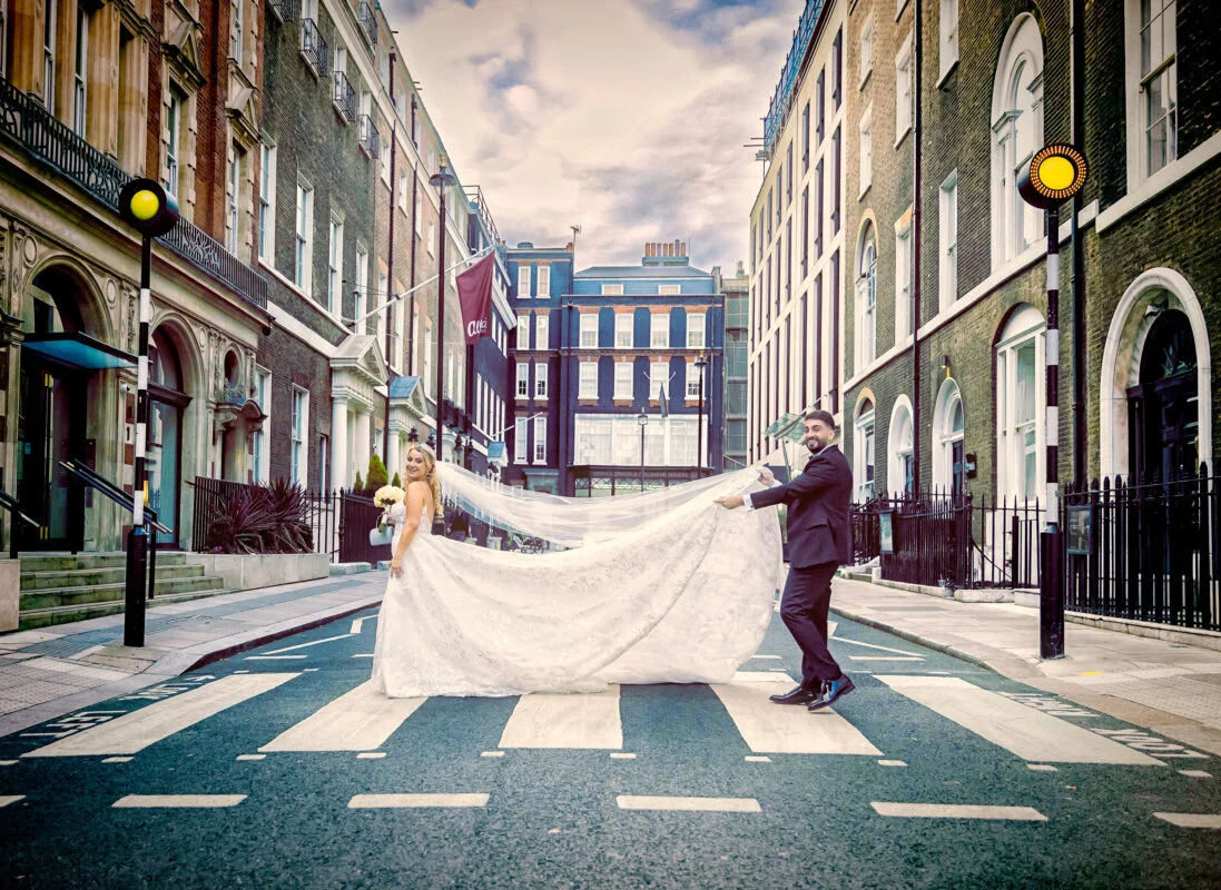 A bride and groom walking down a street in london.