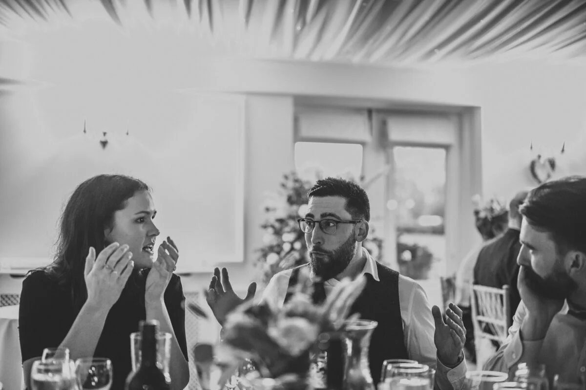 A black and white photo of a group of people at a table.