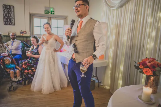 A bride and groom giving a speech at their wedding.