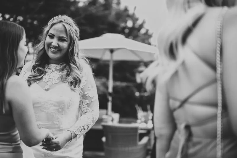 Black and white photo of bride and bridesmaids at a wedding.