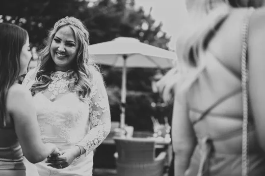 Black and white photo of bride and bridesmaids at a wedding.