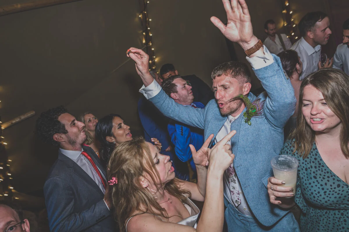 A group of people dancing at a party.