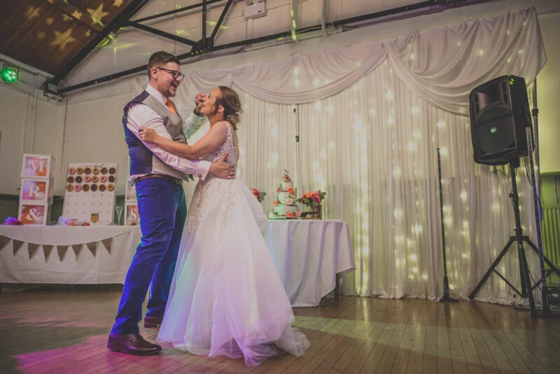 A bride and groom sharing their first dance at their wedding reception.