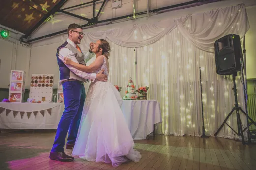A bride and groom sharing their first dance at their wedding reception.