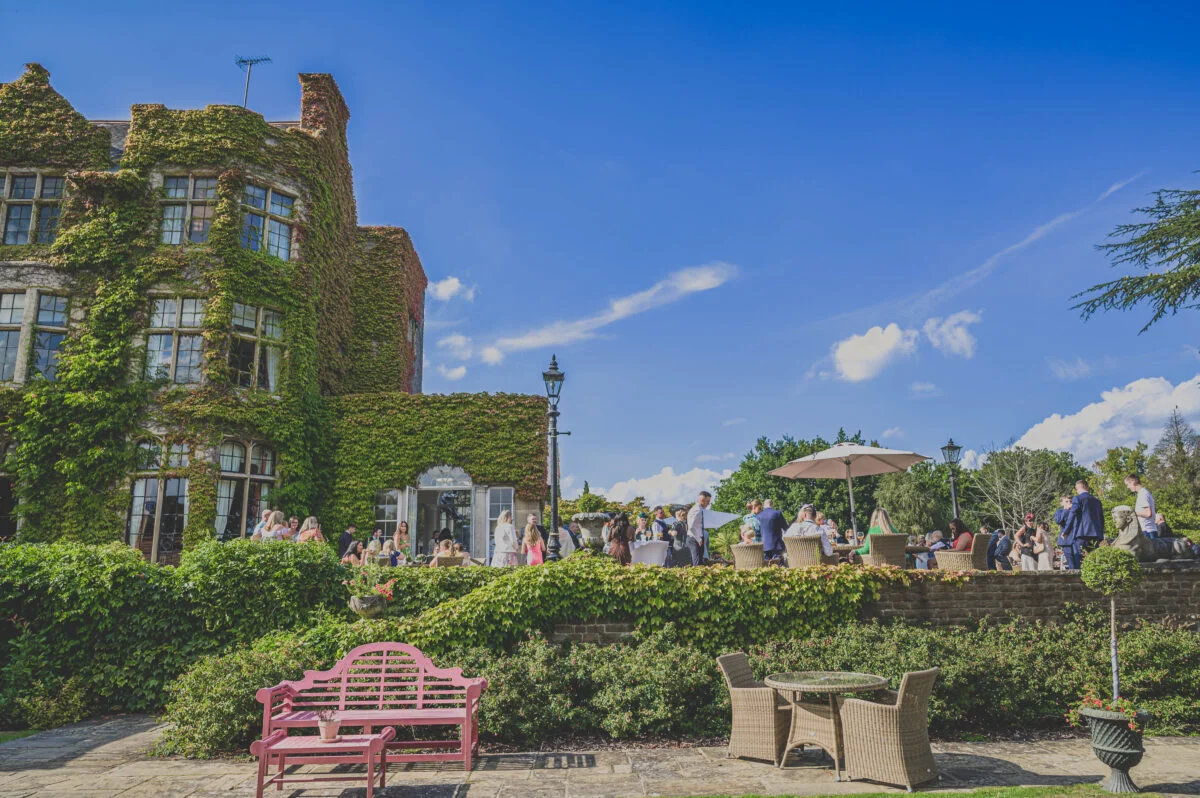 A group of people sitting on a bench in front of a large building.