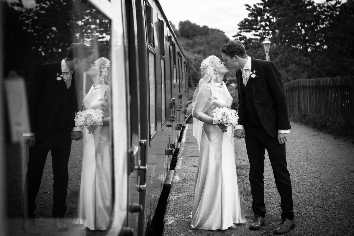 wedding_couple_kissing_next_to_train-2x-b500bba7