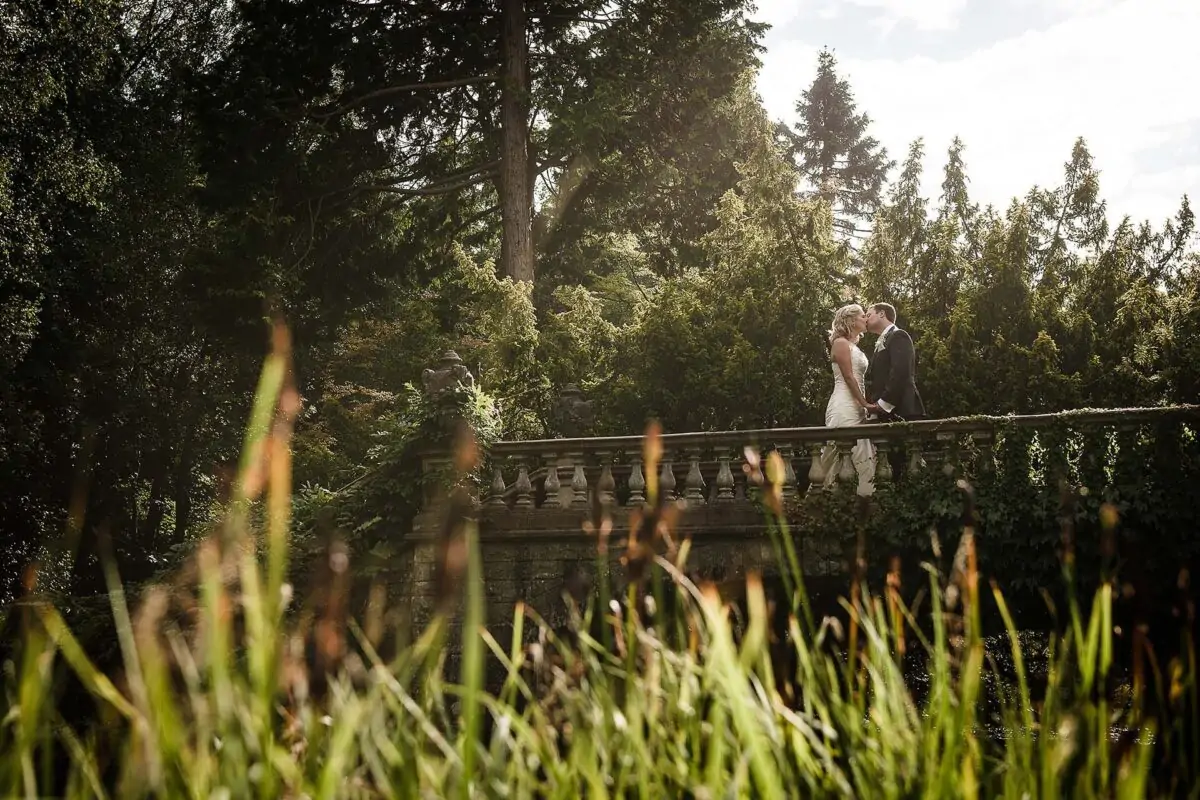 bride_and_groom_kissing_on_bridge-2x-423d194b