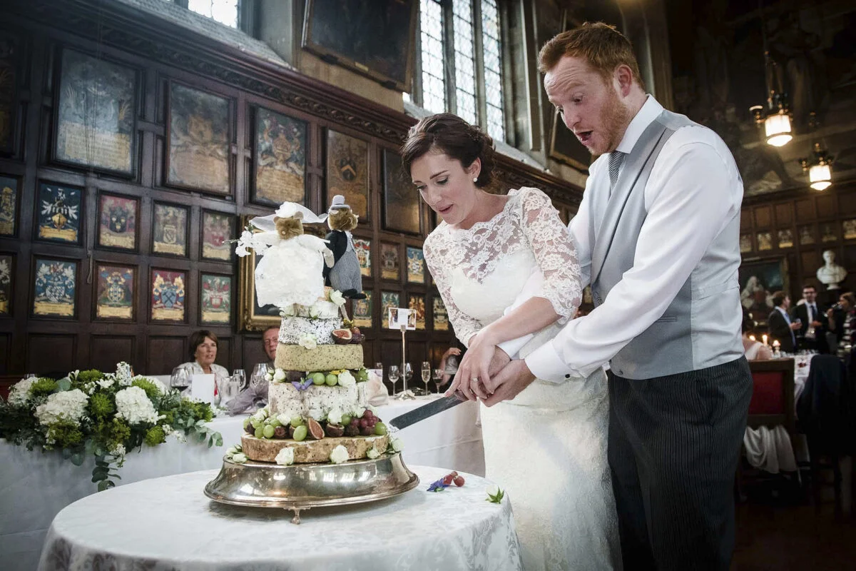A bride and groom cutting their wedding cake.