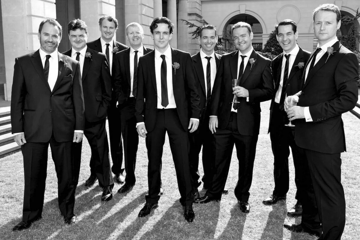 A black and white photo of a group of men in suits.