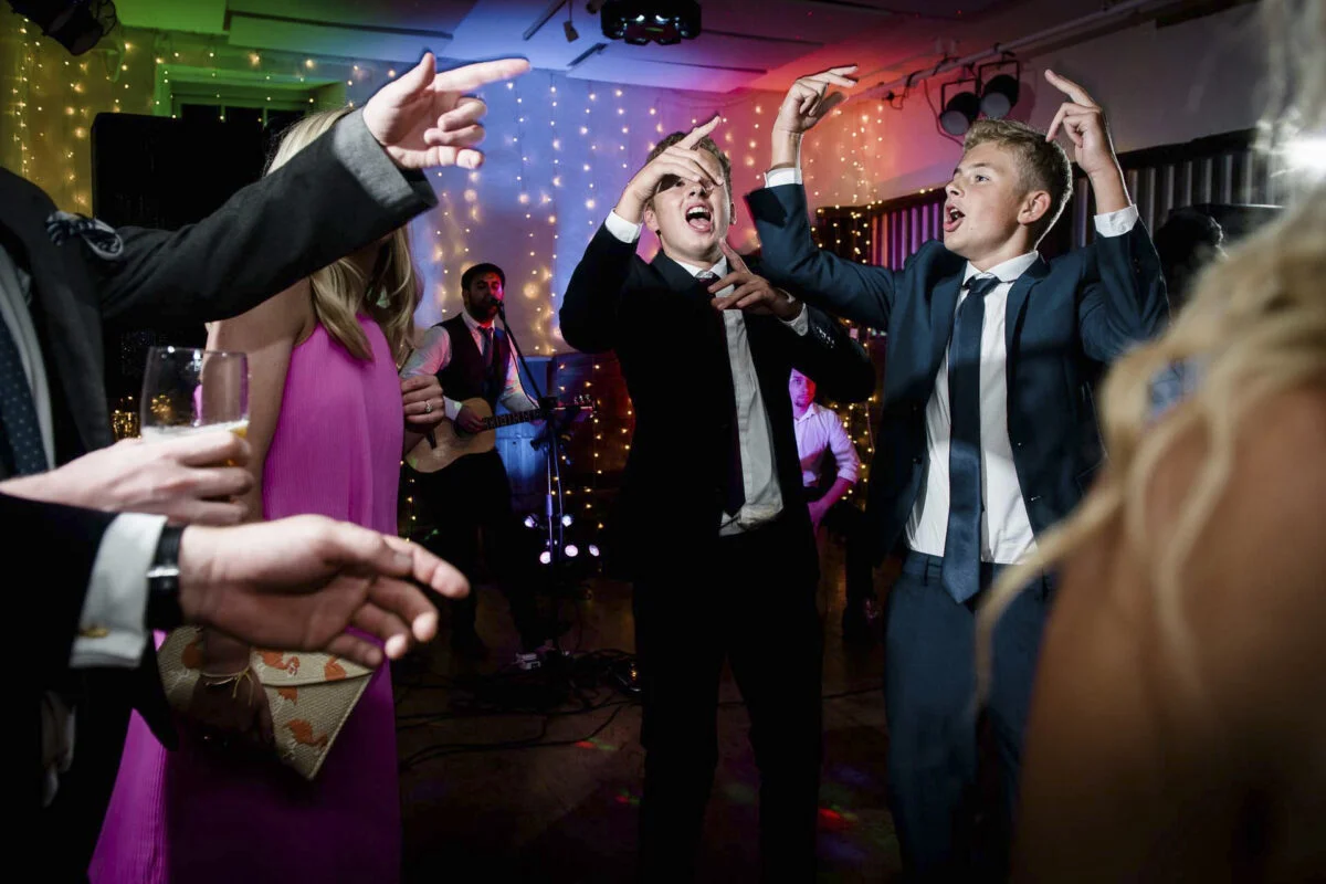 A group of people dancing at a wedding reception.