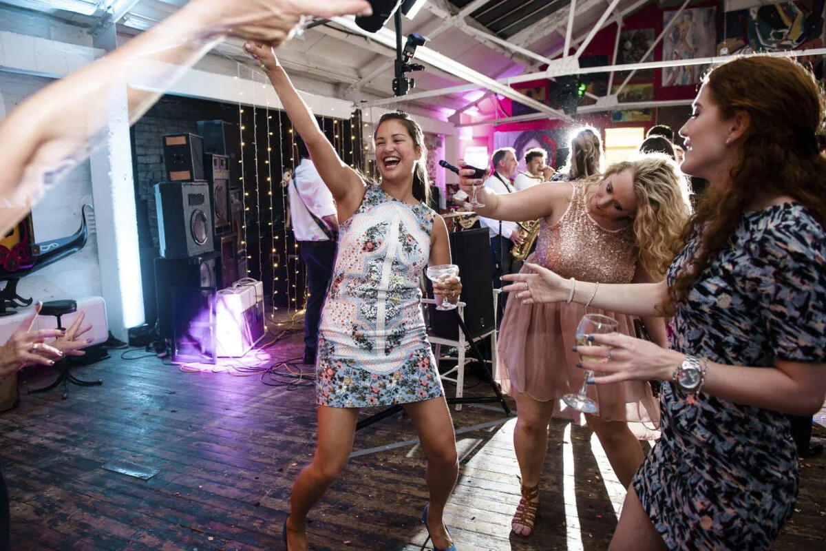 A group of people dancing at a wedding reception.