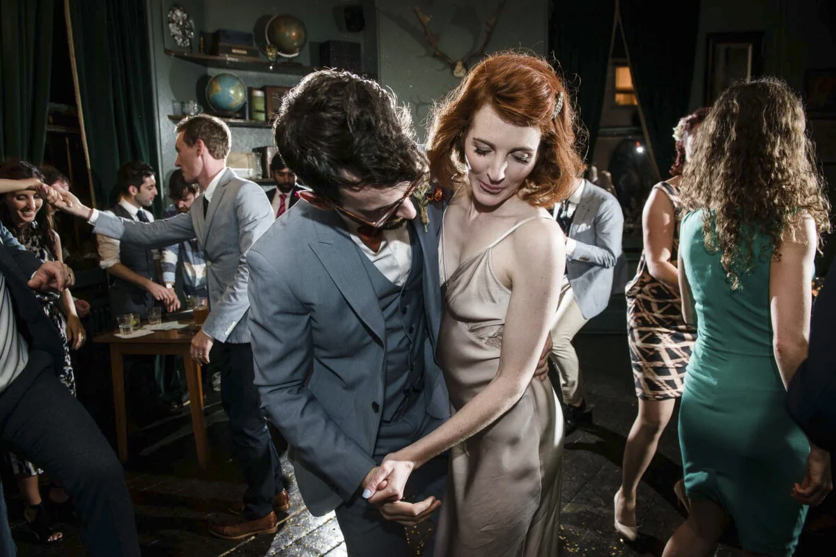 A man and woman dancing at a party.