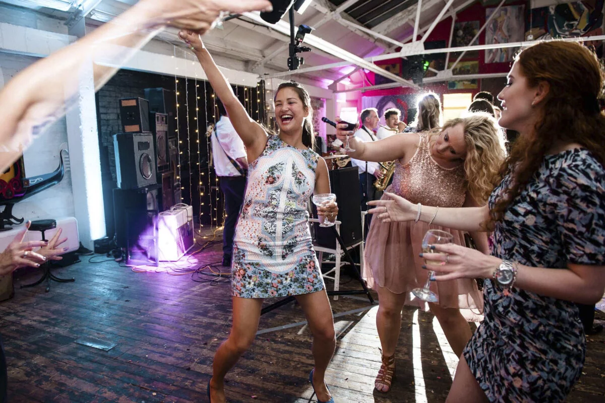 A group of people dancing at a wedding reception.