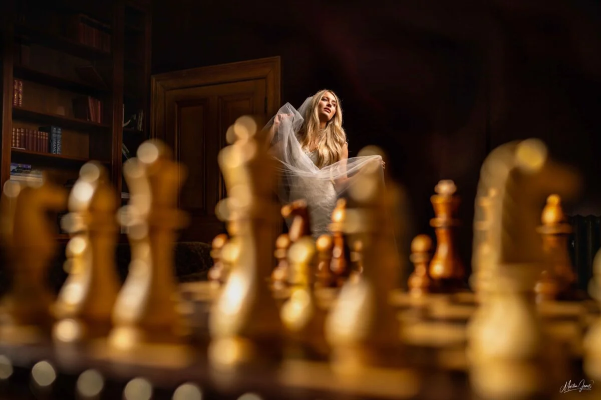 A bride standing in front of a chess board.