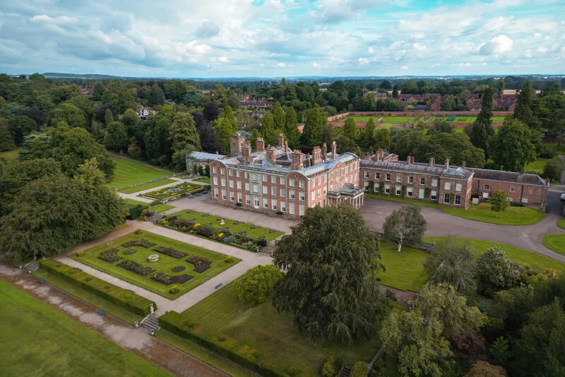 An aerial view of a large mansion.