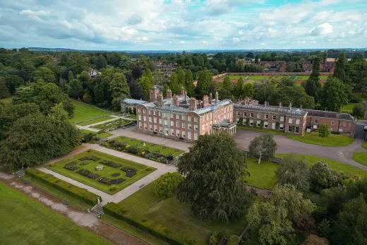 An aerial view of a large mansion.