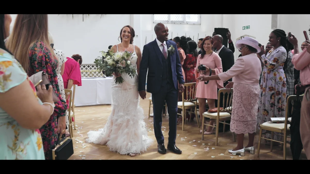 A bride and groom walking down the aisle at a wedding.