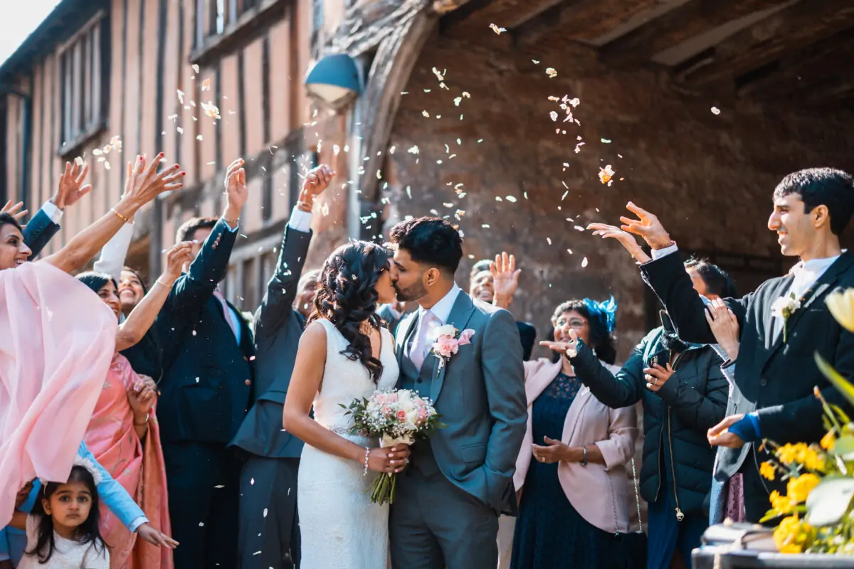 A wedding party throwing confetti at each other.