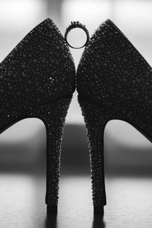Black and white photo of a pair of high heeled shoes.