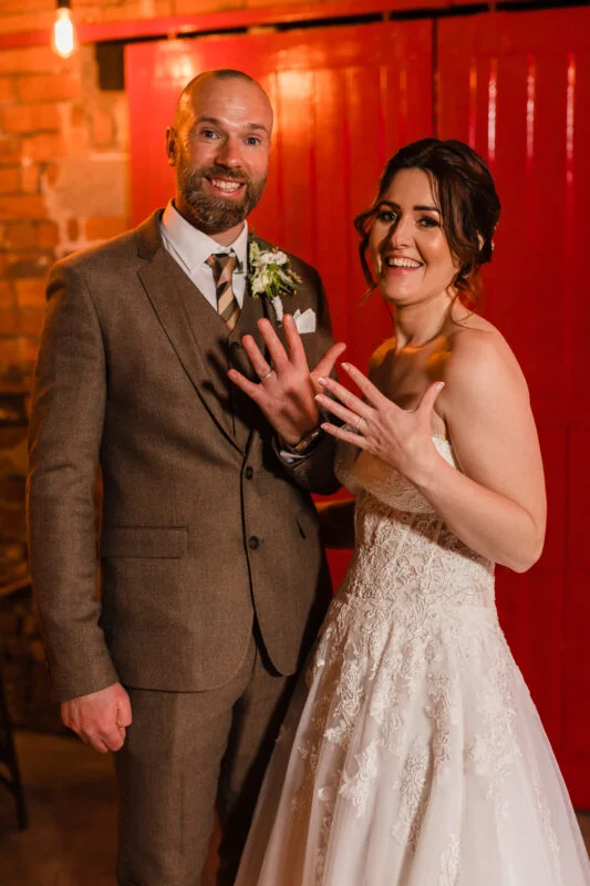 A bride and groom posing for a photo.
