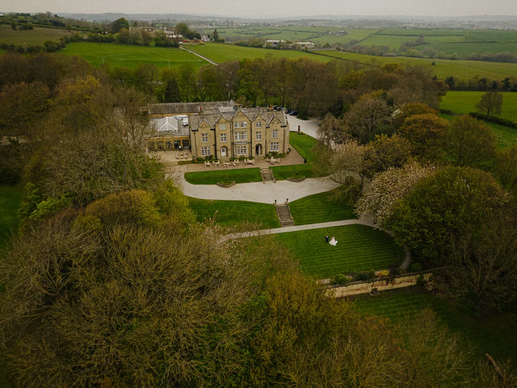 An aerial view of a large mansion.