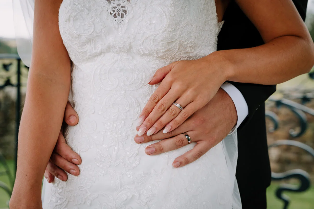 A bride and groom holding each other's hands.