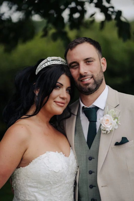 A bride and groom posing for a photo.