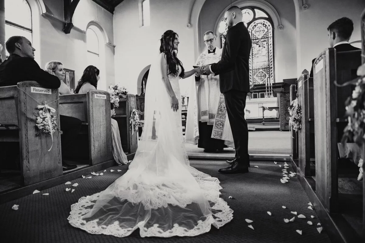 A bride and groom exchange vows in a church.