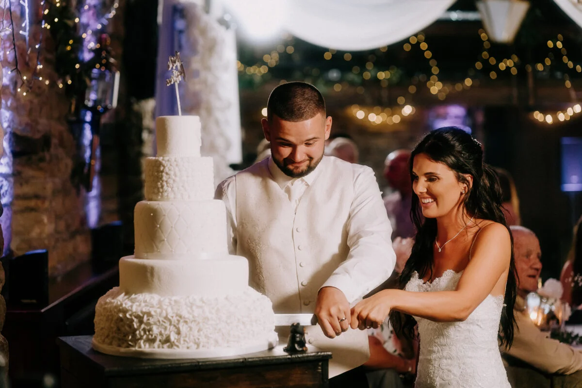 A bride and groom cutting their wedding cake.