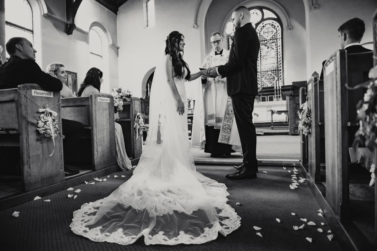 A bride and groom exchange vows in a church.
