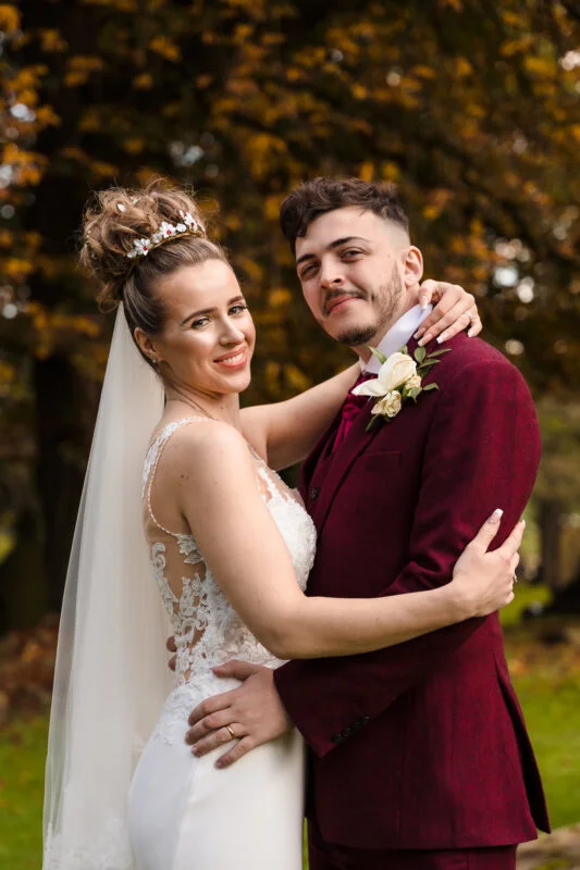 A bride and groom posing for a wedding photo.