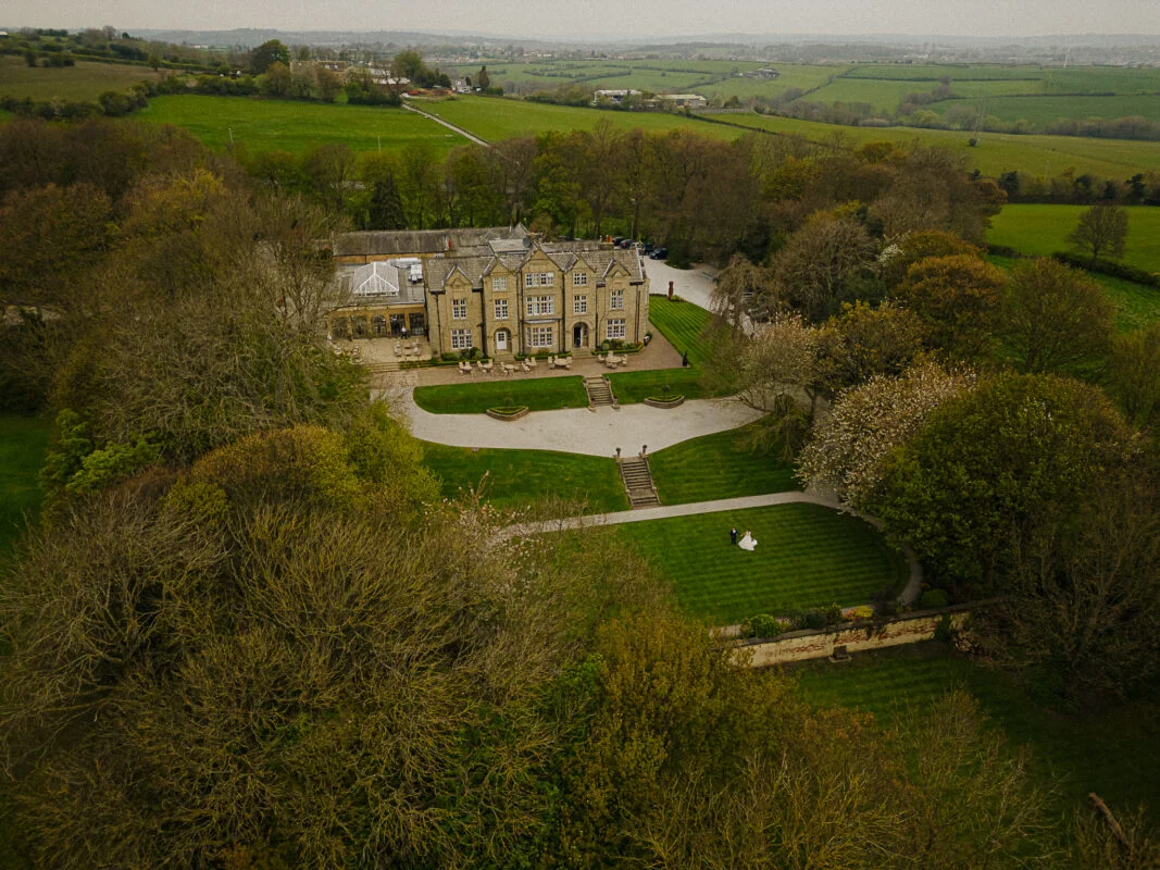 An aerial view of a large mansion.