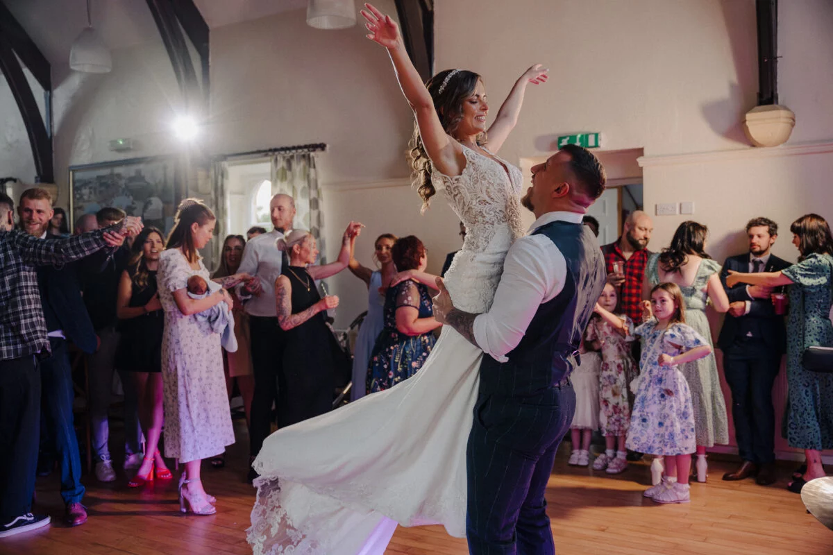 A bride and groom dancing at a wedding reception.