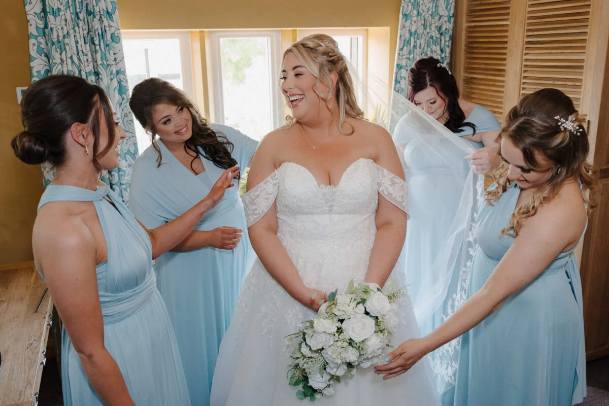 A bride and her bridesmaids are getting ready for their wedding.