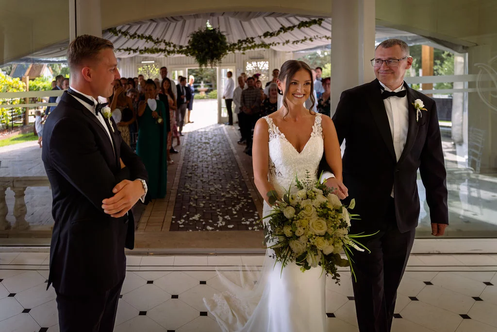 A bride and groom walking down the aisle.