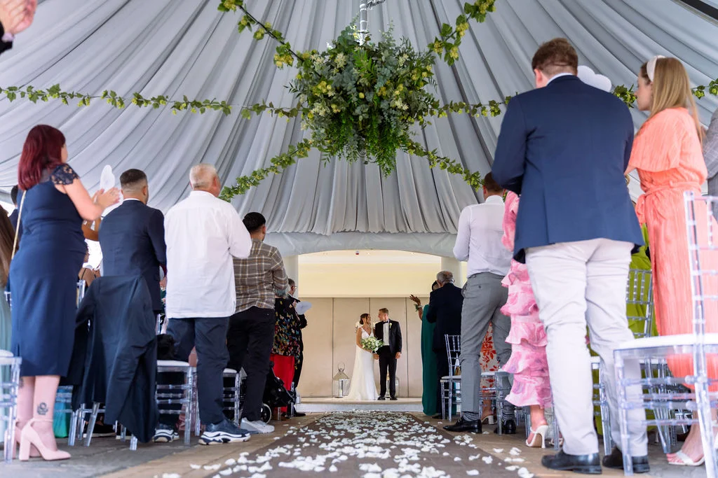 A wedding ceremony under a tent.