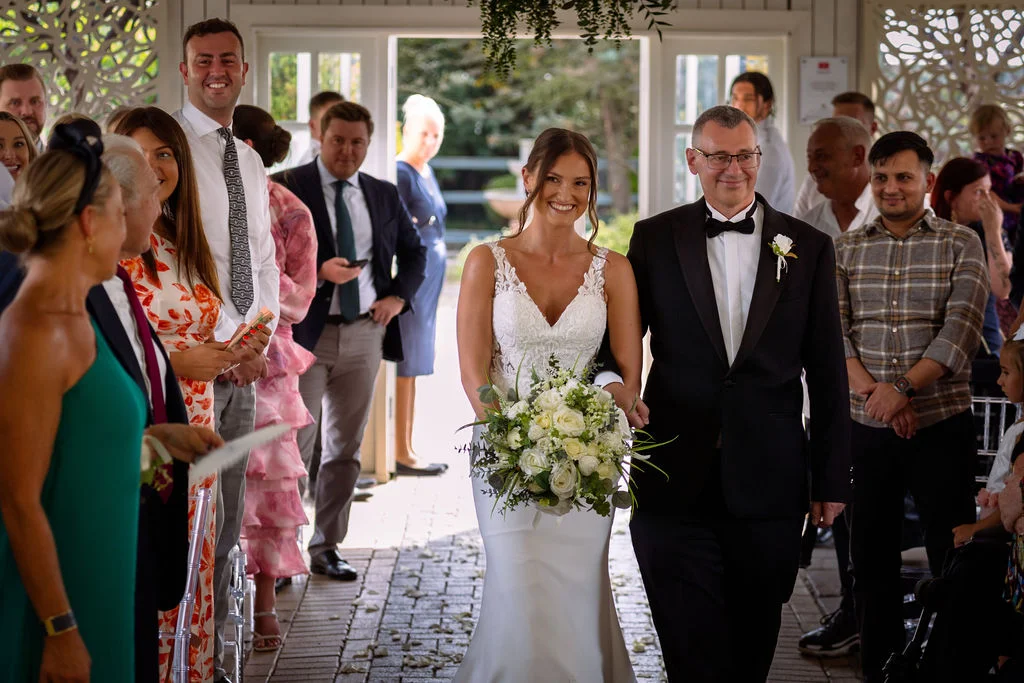 A bride and groom walking down the aisle.