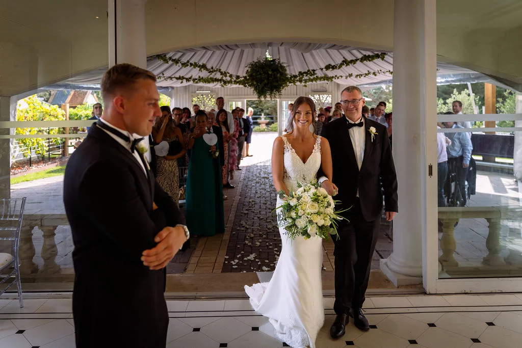 A bride and groom walking down the aisle at a wedding.