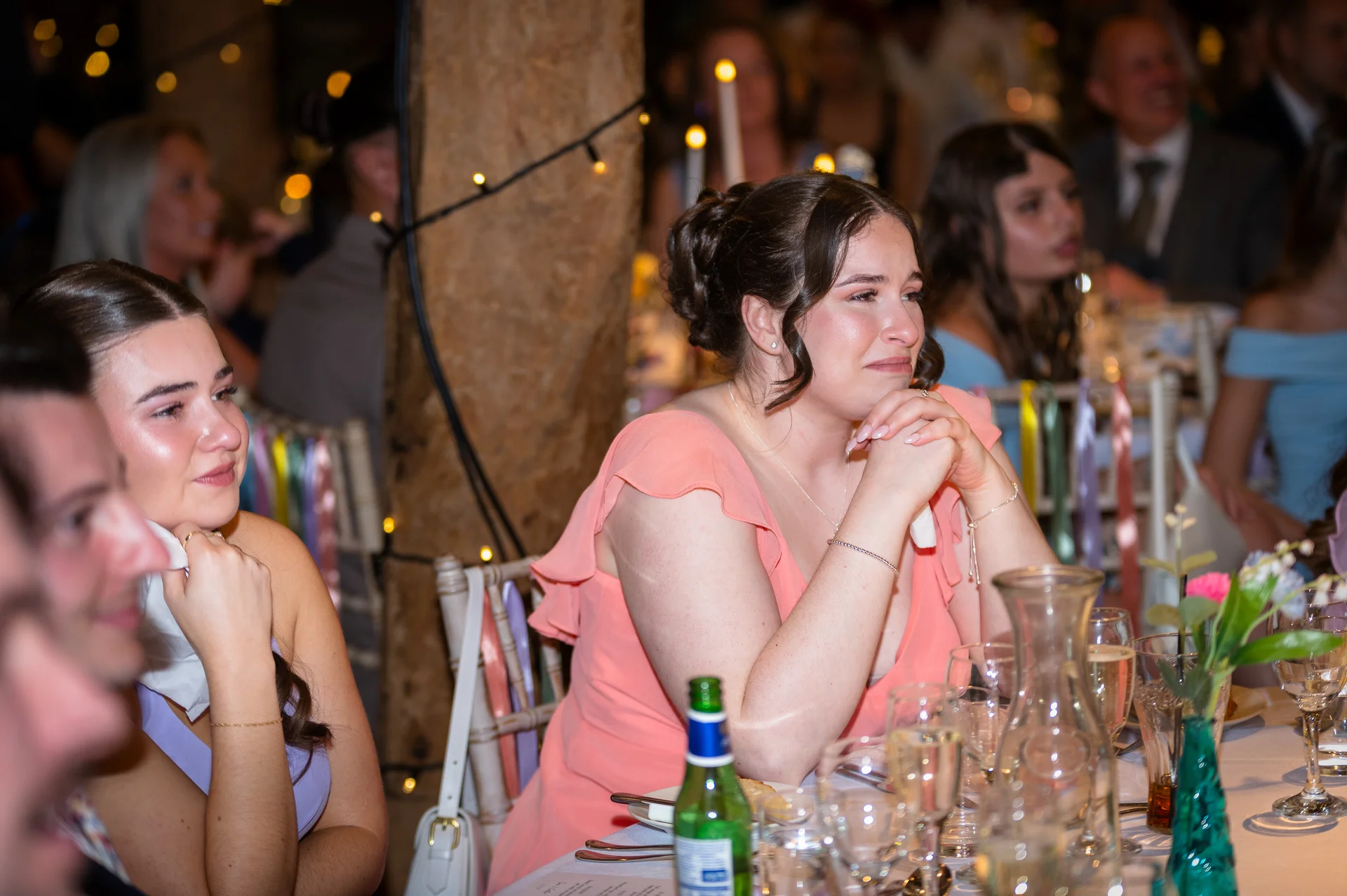 Emotional guests are moved to tears while listening to speeches during the wedding reception.