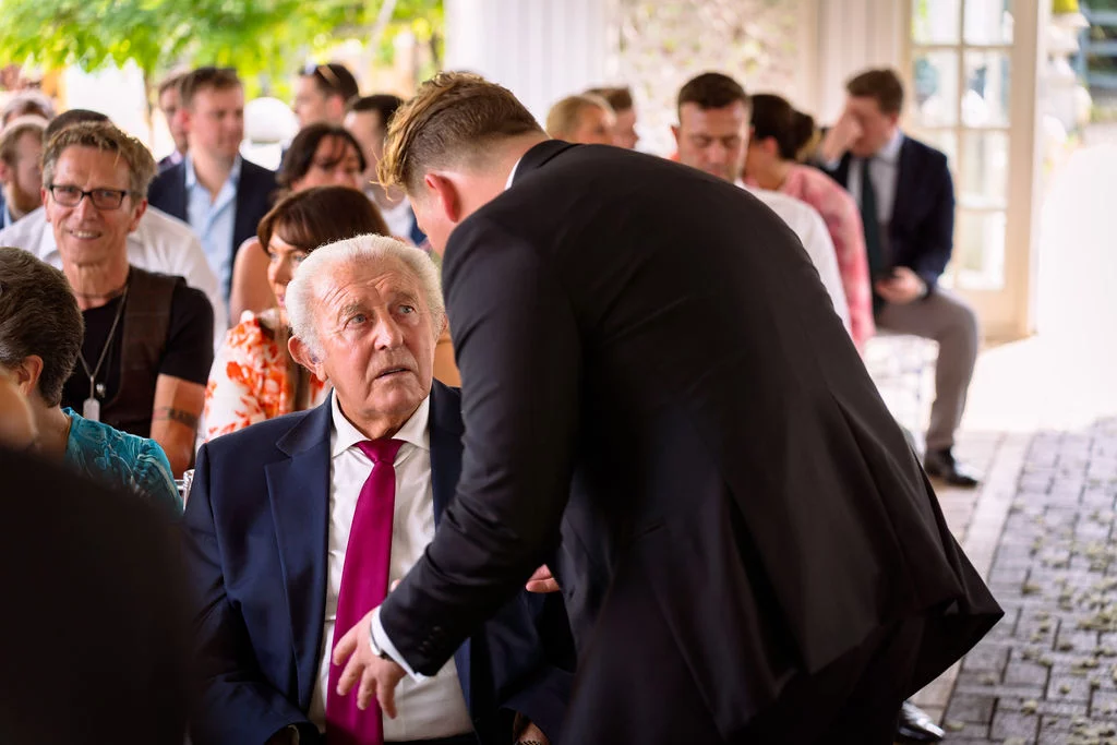 A man in a suit is talking to a man in a suit.